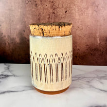 Load image into Gallery viewer, Canister (Medium size) for beautiful display and storage. this canister is made from red stoneware clay, carved with a pattern and glazed in a speckled white glaze. the canister has a natural, rough cork lid. 