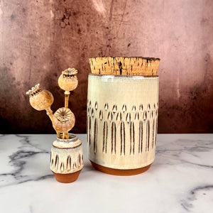 Canister (Medium size) for beautiful display and storage. this canister is made from red stoneware clay, carved with a pattern and glazed in a speckled white glaze. the canister has a natural, rough cork lid. shown here with a mini bud vase, sold separately.