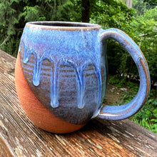 Load image into Gallery viewer, Wheel thrown and hand crafted in red-brown stonware clay, this angle dipped mug is featured in a drippy light blue glaze which lets the red clay show through. beautiful light blue mottled color and textures. holds 14-16 oz. Fern Street Pottery. Angle dipped mug.