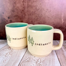 Load image into Gallery viewer, Wheel thrown mug, City Mug with indianola and images of evergreen trees. white stoneware clay, turquoise glaze inside