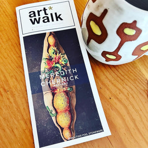 image of flyer for first friday art walk where my seedpod sculptures were featured. midmod mug is also shown