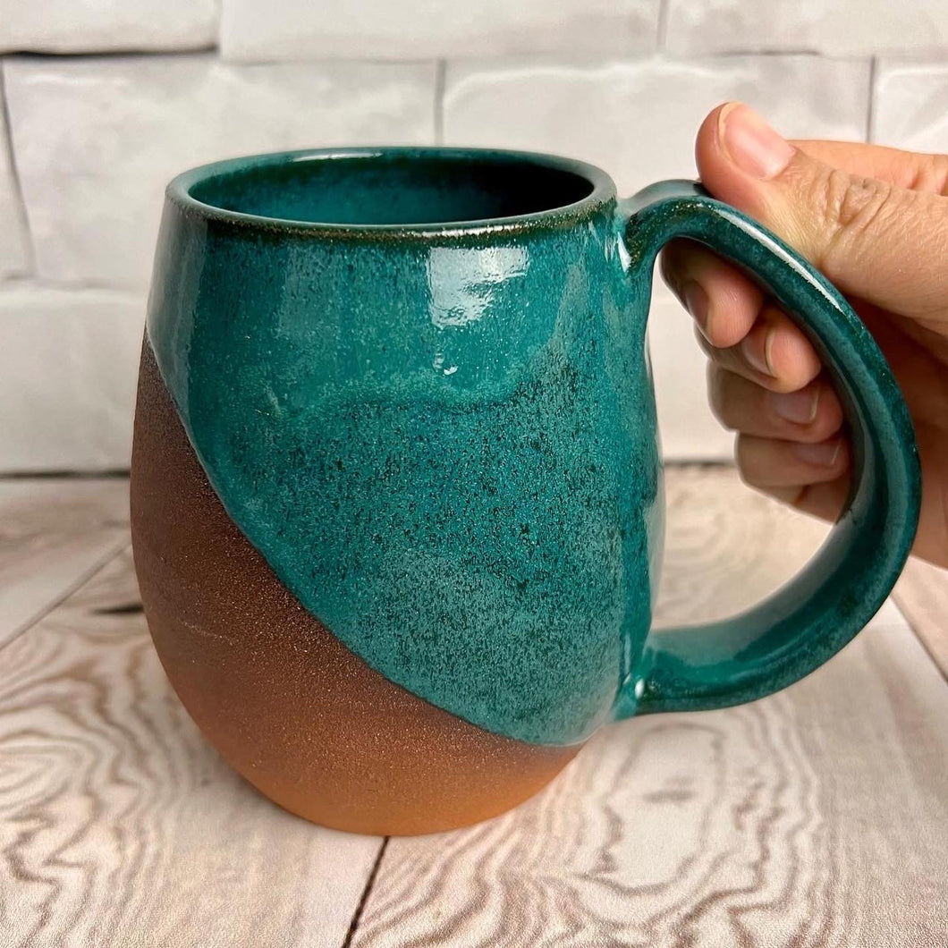 angle dipped mug with Teal Glaze over deep red stoneware clay. beautiful color and textures
