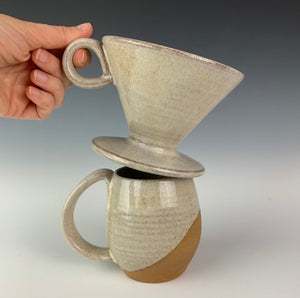 showing the pour over and one mug from the coffee gift set including two angle dipped coffee mugs, one coffee pour over and a matching bud vase. handcrafted, wheel thrown stoneware pottery