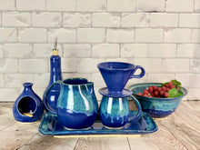 Load image into Gallery viewer, Hand crafted pottery from Fern Street Pottery. Blue world mug, pitcher, tray and colander. Coffee pour over, oil cruet, and salt cellar in cobalt blue.
