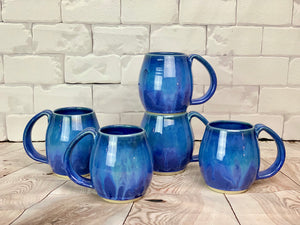 A collection of Blue World Mugs. each one is a little different, but they are well matched.