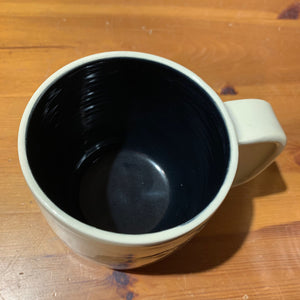 A custom mug shown with black glaze upgrade inside.