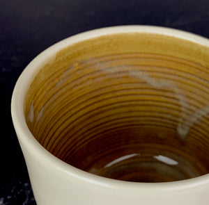 a custom mug shown with brown glaze upgrade inside