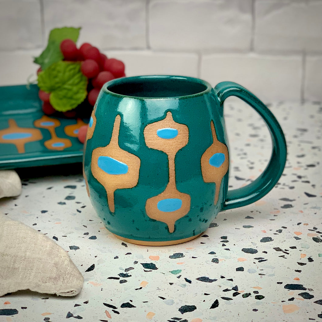 MidMod Mugs and trays in teal, handcrafted by meredith at Fern Street pottery is vintage style, but freshly made by hand to compliment your mid century modern decor. Fern Street Pottery. dishwasher safe, holds 14 - 16 oz.