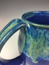 Load image into Gallery viewer, detail shot of Blue World Glaze on a mug. pulled handle, with thumb groove, pottery mug