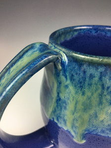 detail shot of Blue World Glaze on a mug. pulled handle, with thumb groove, pottery mug