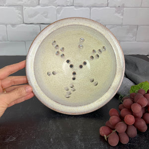 A wheel thrown pottery colander in speckled white glaze. 8" diameter colander
