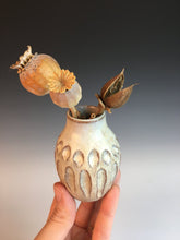 Load image into Gallery viewer, Pottery bud vase, carved detail in red clay with white glaze over it. Shown here with dried seed pods.