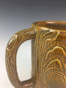 detail shot of pottery mug carved to look like wood. Fern Street Pottery.