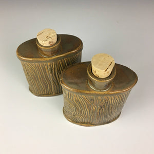 lumberjack pottery flasks shown from above, cork stoppers