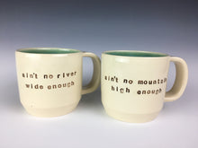 Load image into Gallery viewer, set of customized text mugs. mugs read : ain&#39;t no river wide enough / ain&#39;t no mountain high enough. white mugs, brown text, turquoise interior