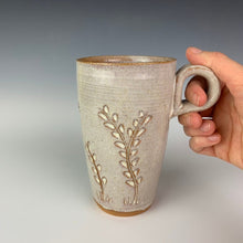 Load image into Gallery viewer, Pottery travel mug with finger loop handle. thrown on the pottery wheel, red clay, carved with vine pattern, white speckled glaze