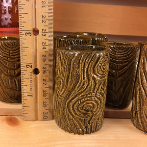 woodgrain carved lumberjack shot glass with ruler for reference. 2.5 " tall