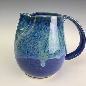 Blue world pottery pitcher. cobalt blue glaze with turquoise glaze play on top half. wheel thrown, artisan pottery
