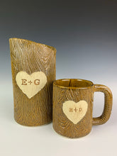 Load image into Gallery viewer, lumberjack, woodgrain appearance on pottery mug and vase. with heart and initials custom carved into surface