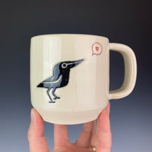 Load image into Gallery viewer, Crow love mug. wheel thrown mug with a crow painted and carved in, and a heart in a speech bubble stamped and glazed with red.