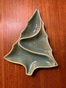 speckled green ceramic tree shaped dish on teak table