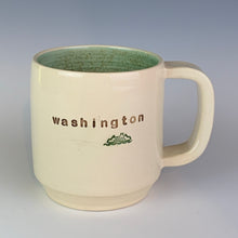Load image into Gallery viewer, Wheel thrown pottery mug with &quot;washington&quot; and an image of a ferry inset on the outside. white outside, green glaze interior