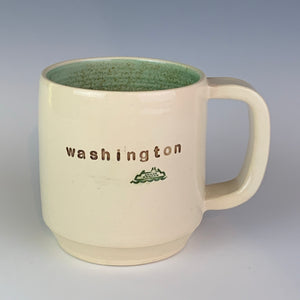 Wheel thrown pottery mug with "washington" and an image of a ferry inset on the outside. white outside, green glaze interior