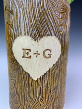 Load image into Gallery viewer, close up detail texture shot of a woodgrain, lumberjack vase. the vase has a heart and initials carved into the wood-like surface