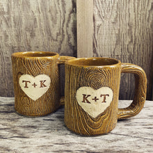 Load image into Gallery viewer, Large custom coffee mug with lumberjack,woodgrain pattern impressed and carved in for texture you can feel. the mug has a heart carved into it with initials, like lovers would carve into a tree